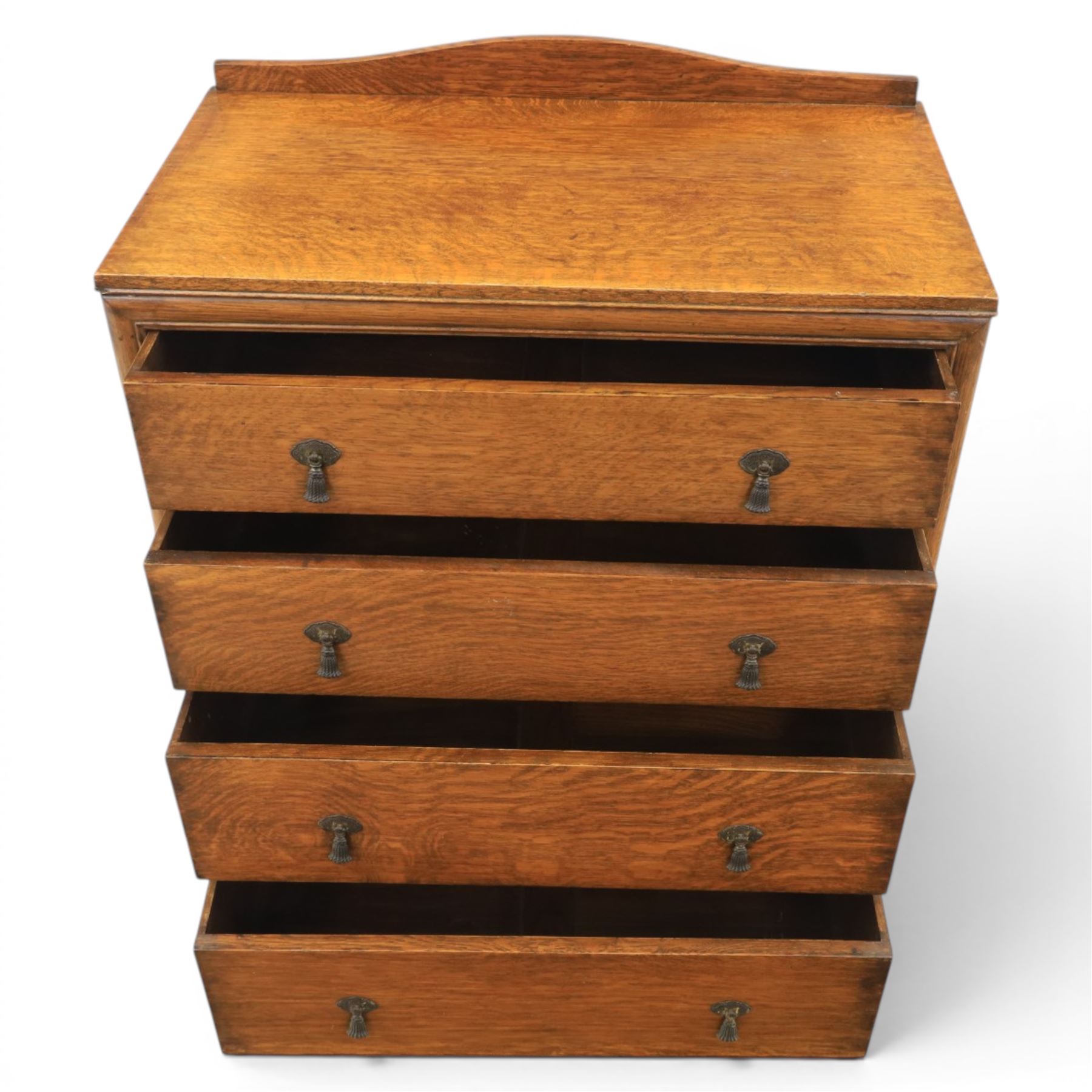 20th century oak chest, shaped gallery top over four graduating drawers, with metal drop handles, raised on stile feet 