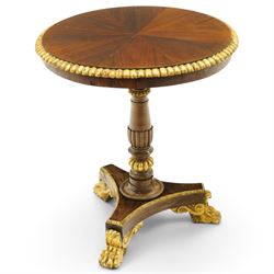 French Empire design rosewood and parcel-gilt occasional table, the circular top with sunburst veneer and giltwood gadrooned edge, raised on a turned and lobed pedestal terminating to a triform platform base with gilt beading, raised on three large paw feet with scrolling foliate brackets