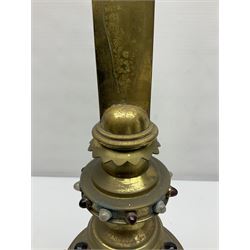 Brass alter cross, decorated with glass cabochons, upon a acicular stepped base and three claw feet, H73cm 