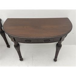 Pair early 20th century Hepplewhite style mahogany D-end console tables, the curved top with foliate carved edge, fluted frieze rails carved with flower heads, turned and reeded acanthus supports with recessed castors