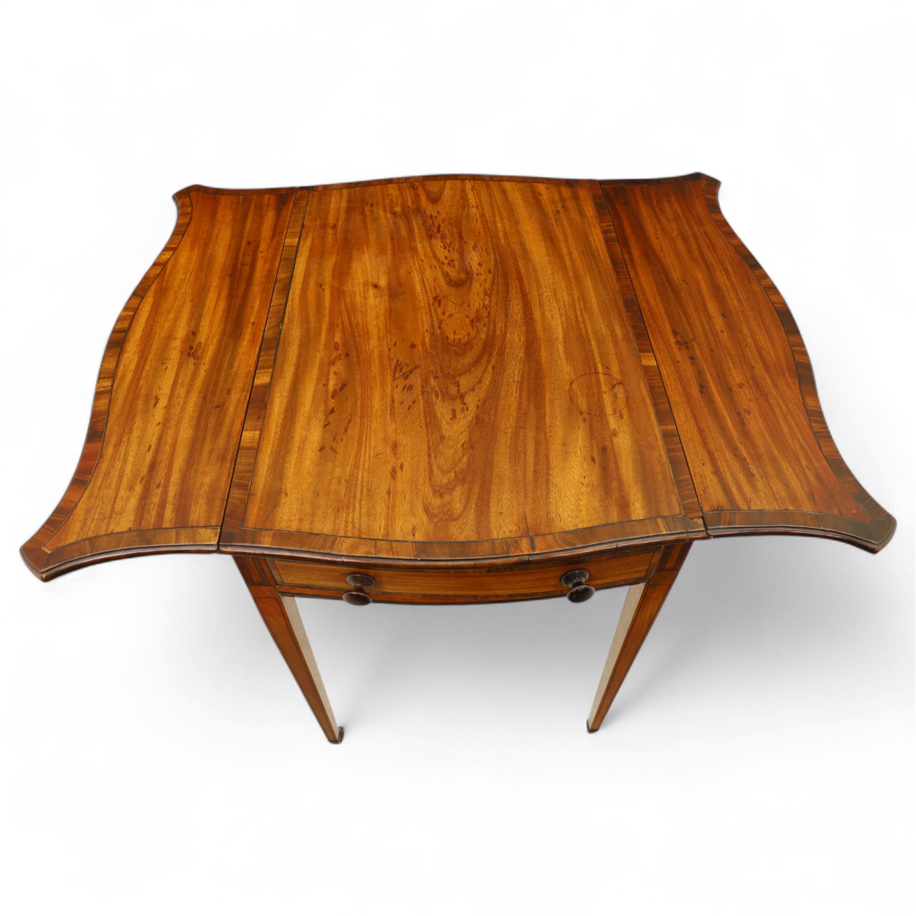 Goergian small butterfly pembroke table, the rectangular top with crossbanded edge and rounded drop leaves, single frieze drawer with opposing dummy drawer, raised on square tapering legs with stringing, terminating in brass castors