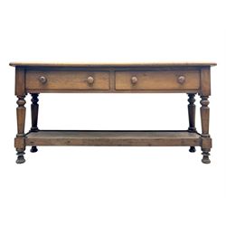 Late 19th century oak potboard dresser base, rectangular top over two frieze drawers with turned wooden handles, raised on four ring turned and tapering supports with block feet, united by a full-width lower potboard