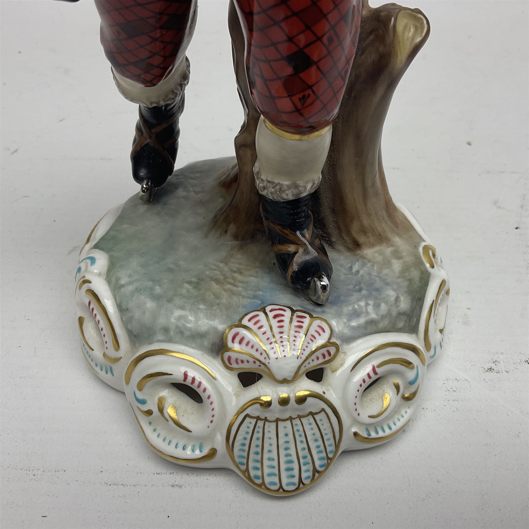 Royal Crown Derby figurine, Winter, modelled as a man with crossed arms on ice skates, by M. Townsend, with printed marks beneath, H24cm