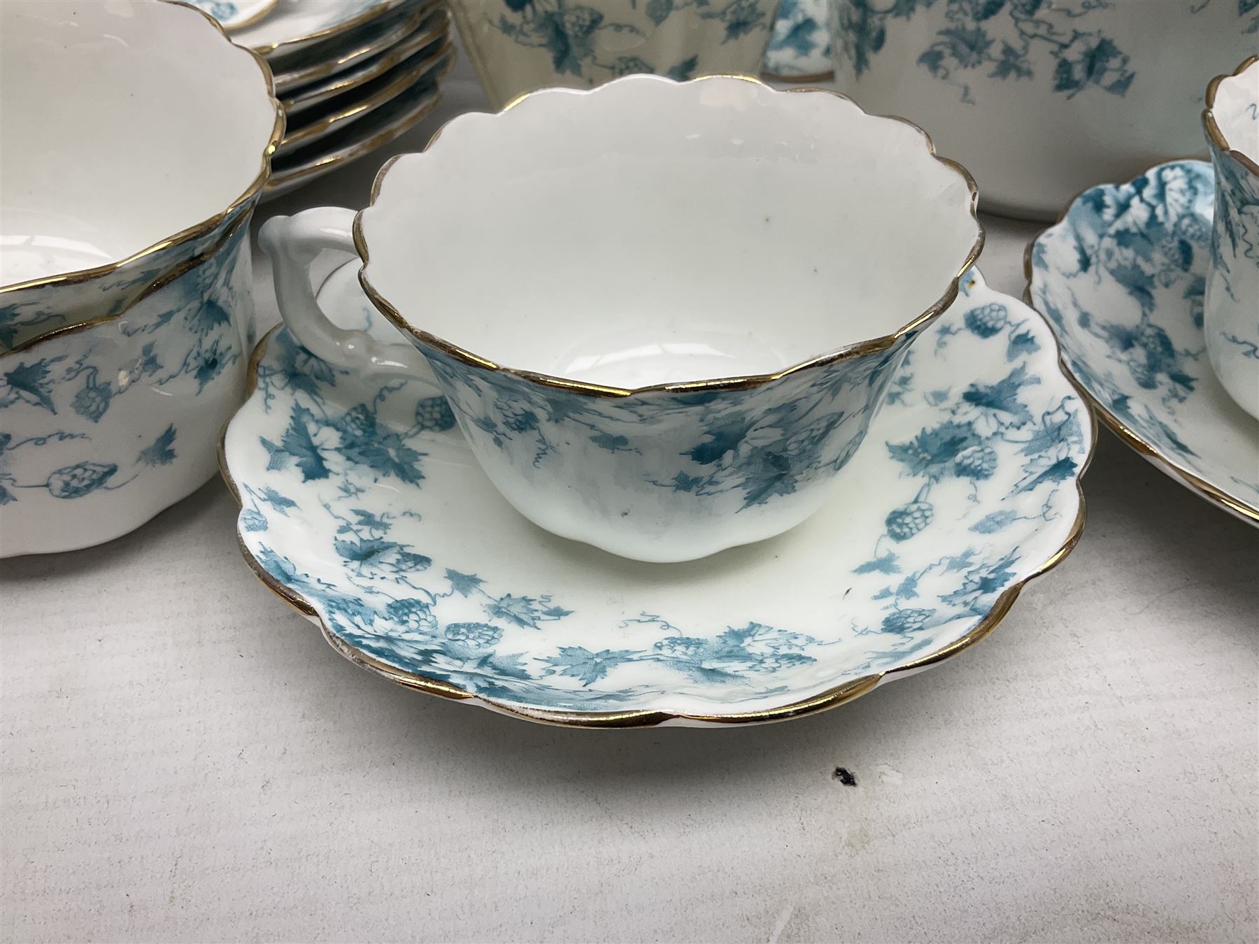 Edwardian David Chapman & Sons tea service for six, of lobed form decorated with blue transfer printed foliate decoration and gilt rims