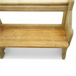 19th century pine pew of small proportions, open rectangular back with panelled frame, rounded top rail and plank seat, shaped slab ends with chamfered detail
