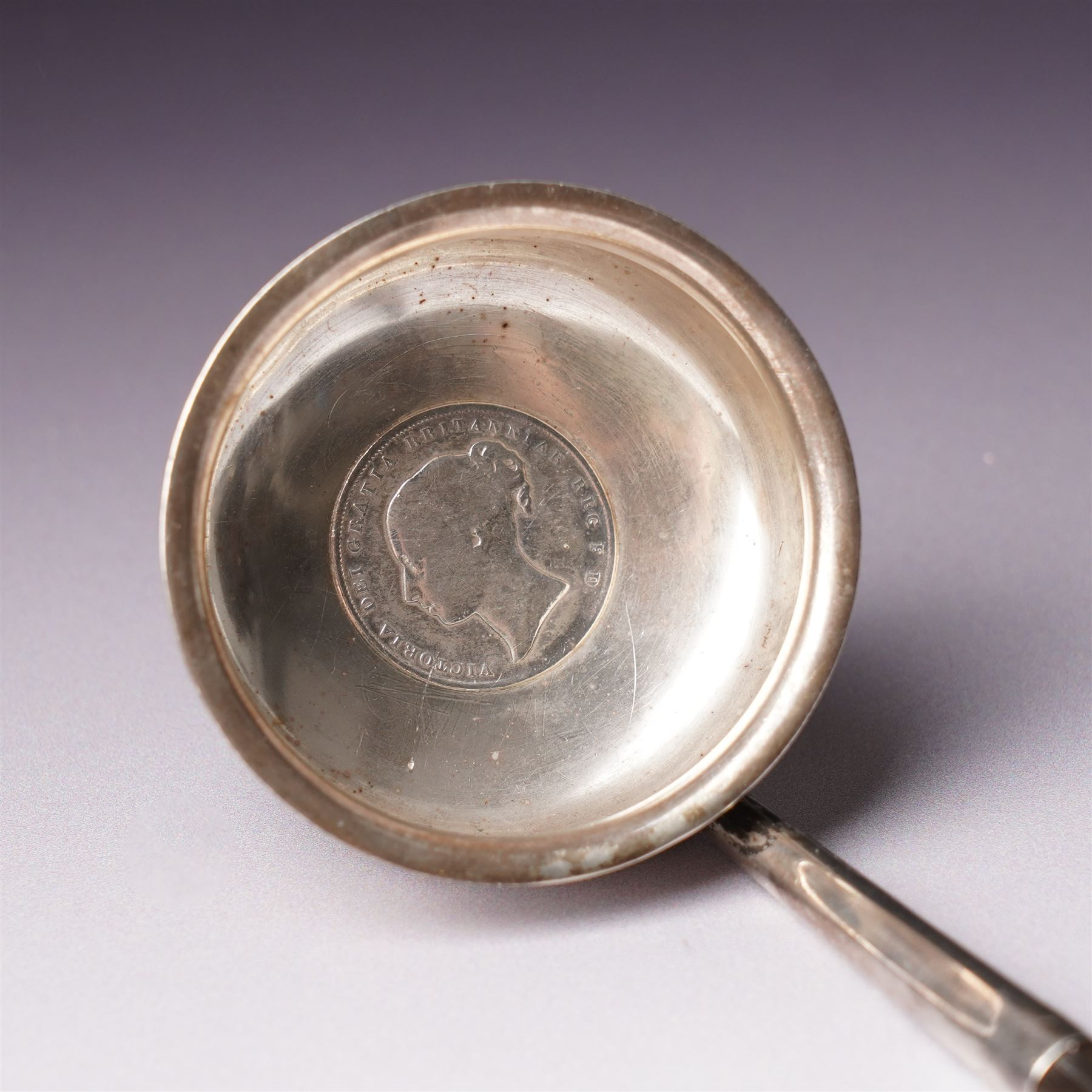 Victorian Scottish silver toddy ladle, the bowl inset with a Victorian shilling coin and with twisted whale bone handle Glasgow 1850 Maker Blaikley & Good, embossed silver drum mustard pot and and an oval mustard pot Sheffield 1902 (3)