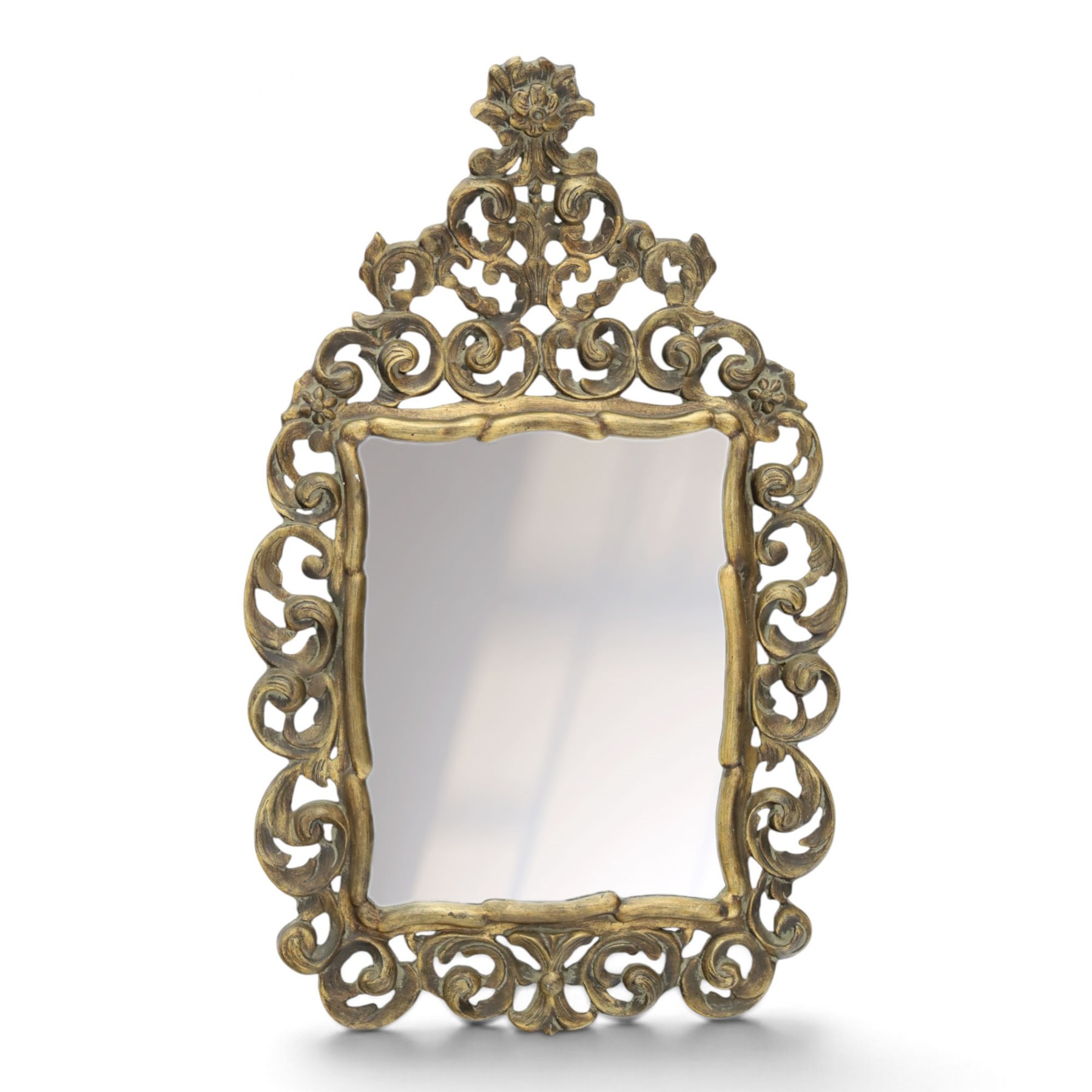 Rococo style gilt wall mirror, the shaped rectangular bevelled plate within a pierced frame of scrolling acanthus leaves, surmounted by a foliate crest