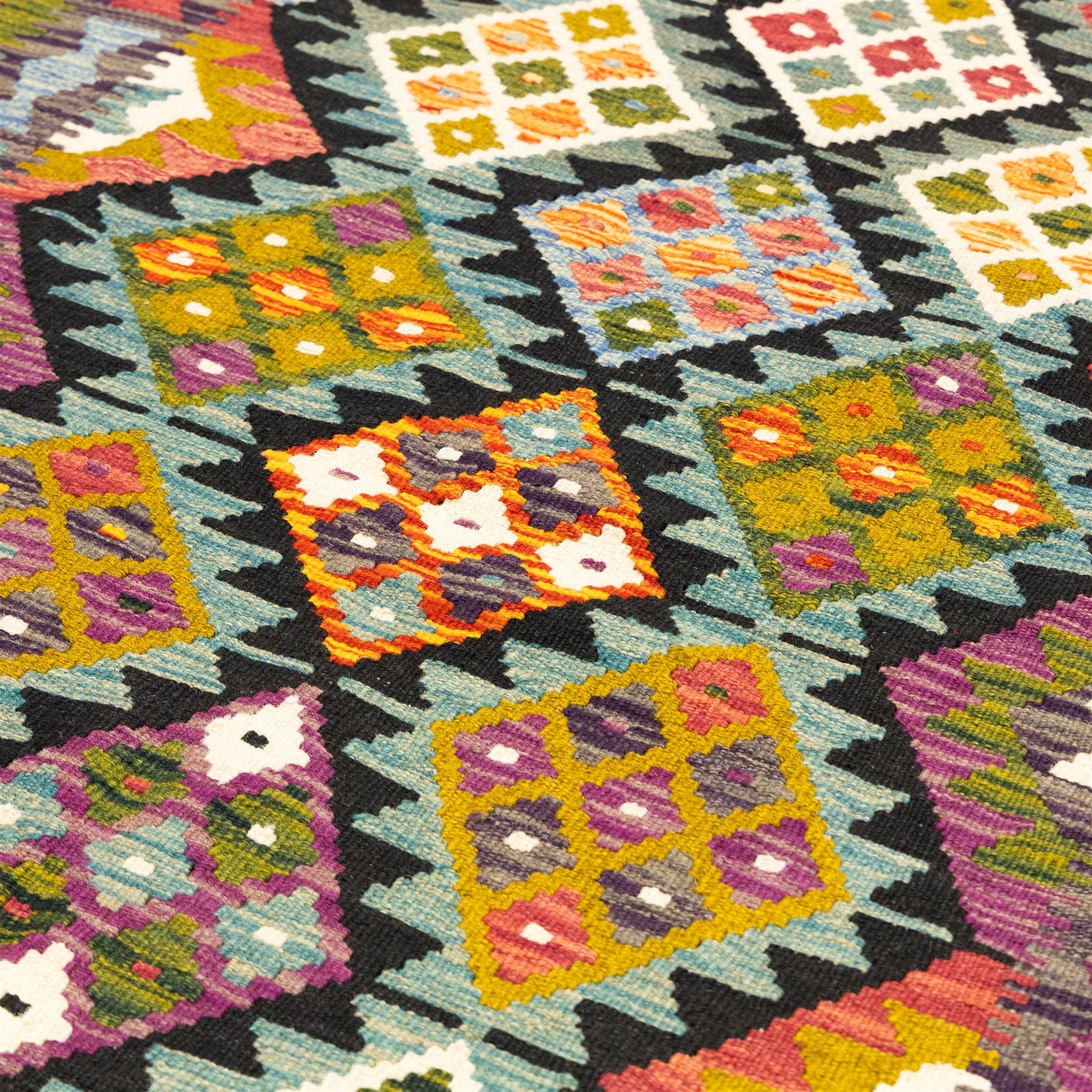 Afghan Maimana flatweave kilim runner, central field features large bold nested diamond motifs and stylized geometric lozenge patterns on olive purple, ochre, blue, and green tone ground, border stripe in orange tones with fringe