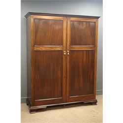 Early 20th century mahogany gentleman's wardrobe, projecting cornice, two panel doors enclosing a hanging rail, shoe rack, three shelves and three drawers, on ogee bracket supports,  'JOHN WATTS SHEFFIELD', W137cm, H176cm, D55cm  
