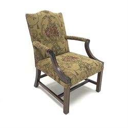  Early 20th century mahogany framed Gainsborough style armchair, upholstered in antique gold fabric featuring dark crimson old rose bouquets with foliate scrolls and tasselled swags, arched cresting rail, out swept arms, square reeded legs joined by cross stretcher, W68cm  