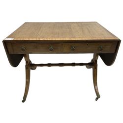 Regency mahogany sofa table, rectangular crossbanded top with twin drop-leaf ends, fitted with single drawer and one faux drawer, raised on shaped end supports united by ring turned stretcher
