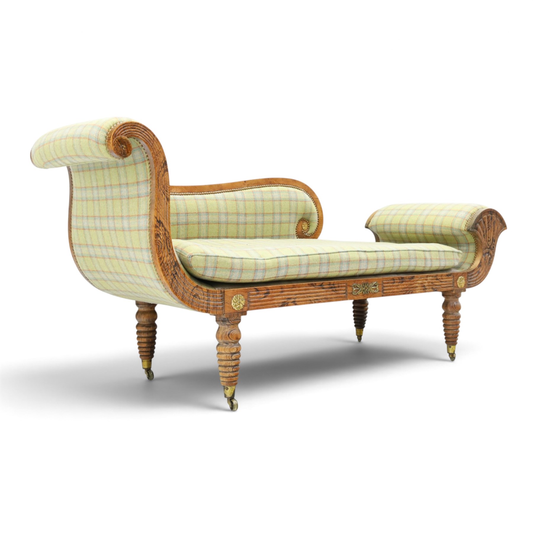  19th century scumbled oak chaise longue upholstered in tartan fabric, swept frame with gilt mounts, studded border with loose base cushion, raised on turned bobbin supports terminating brass castors