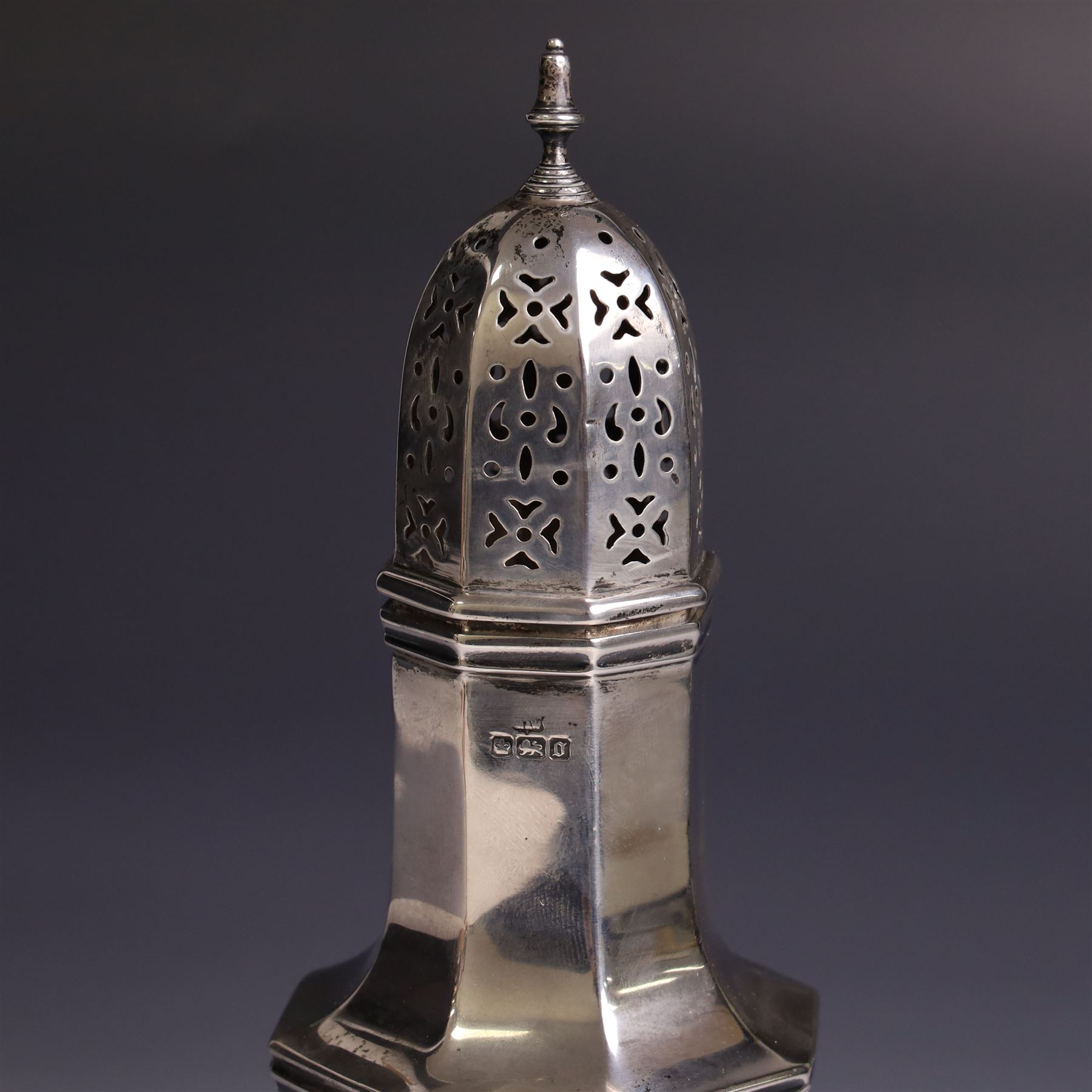Edwardian silver sugar caster, of typical for with removable pierced cover and upon octagonal foot, hallmarked Mappin & Webb Ltd, Sheffield 1906, H21cm