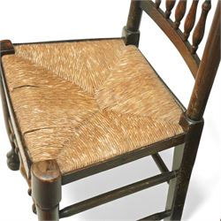 20th century set of five spindle-back dining chairs, with shaped top rails above turned spindle splats, rush seats, turned forelegs united by stretchers