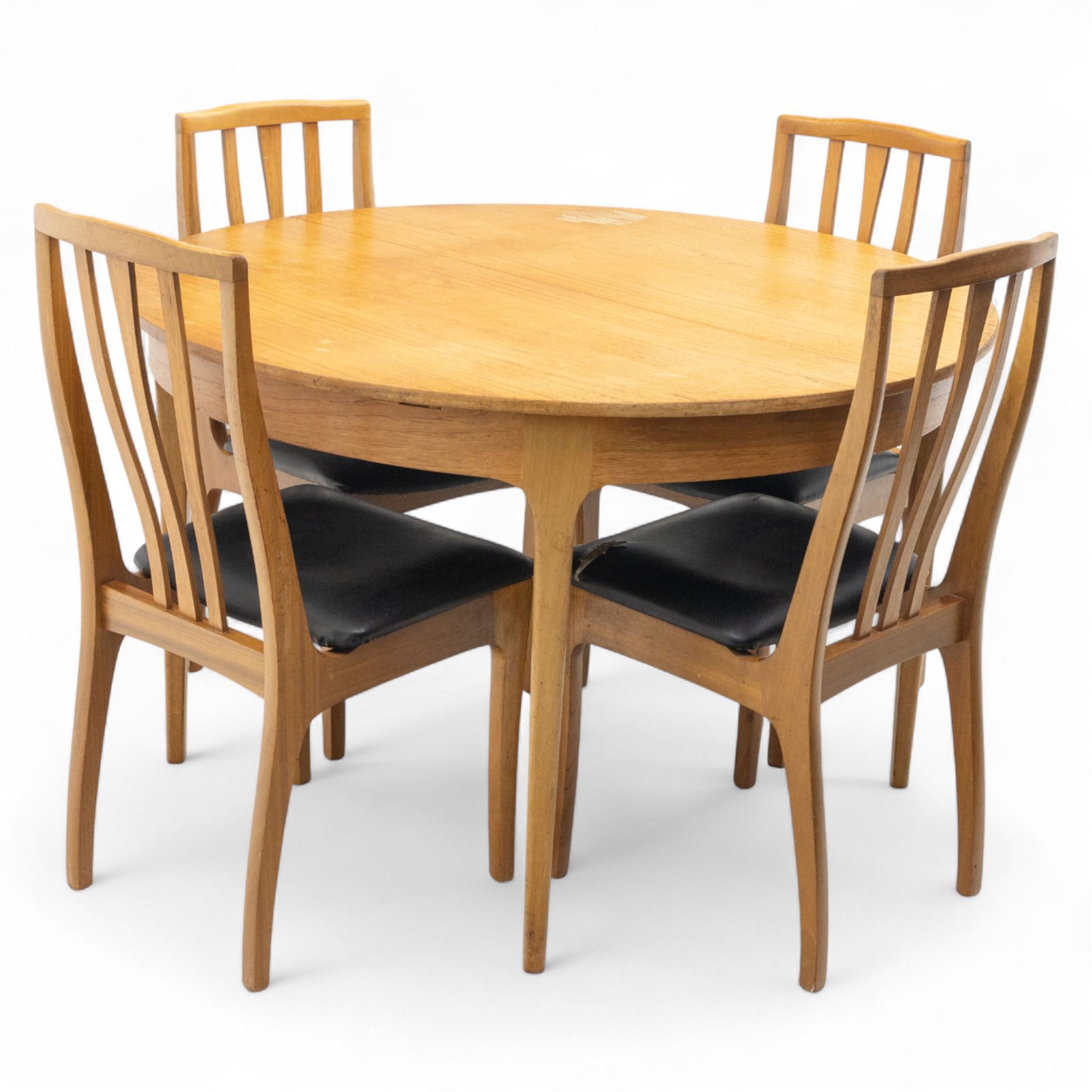 Sutcliffe of Todmorden - mid 20th century ‘S-Form’ teak dining table and chairs, the circular storable extending table with plain veneered top on tapered supports, together with matching dining chairs upholstered in black vinyl, with curved slat backs and shaped front supports, reflecting the sleek organic styling characteristic of 1960s British modern furniture design (Chairs H 93cm, W 46cm, D 46cm) (Extended 168cm)