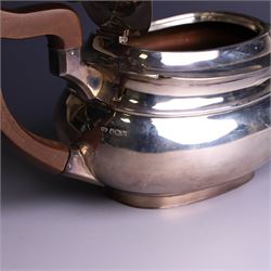 1930s three piece silver tea service, comprising teapot with wooden handle and finial, open sucrier and milk jug, hallmarked Viners Ltd, Sheffield 1930