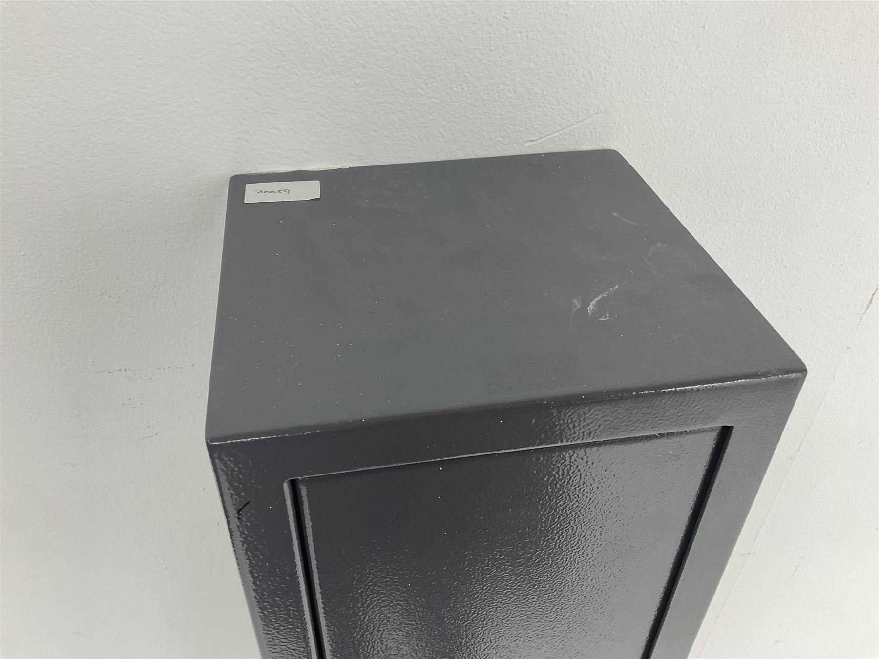 Grey steel wall mounting gun cabinet to accommodate three guns; single door with two locks with two keys for one lock; internally H128.5cm W21cm D17.5cm; externally H129cm W21.5cm D20cm