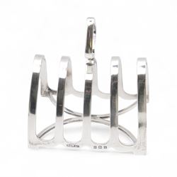 Group of silver, comprising 1930s five bar toast rack, hallmarked B & W Ltd, Birmingham 1931, three piece Edwardian silver cruet set comprising two open salts and a pepper shaker, hallmarked E J Trevitt & Sons, Chester 1904 and a small 1930s silver sauce boat, hallmarked Edward Barnard & Sons Ltd, London 1937 