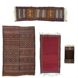Group of four late 20th century wool kilim rugs, comprising a narrow tribal runner with st...