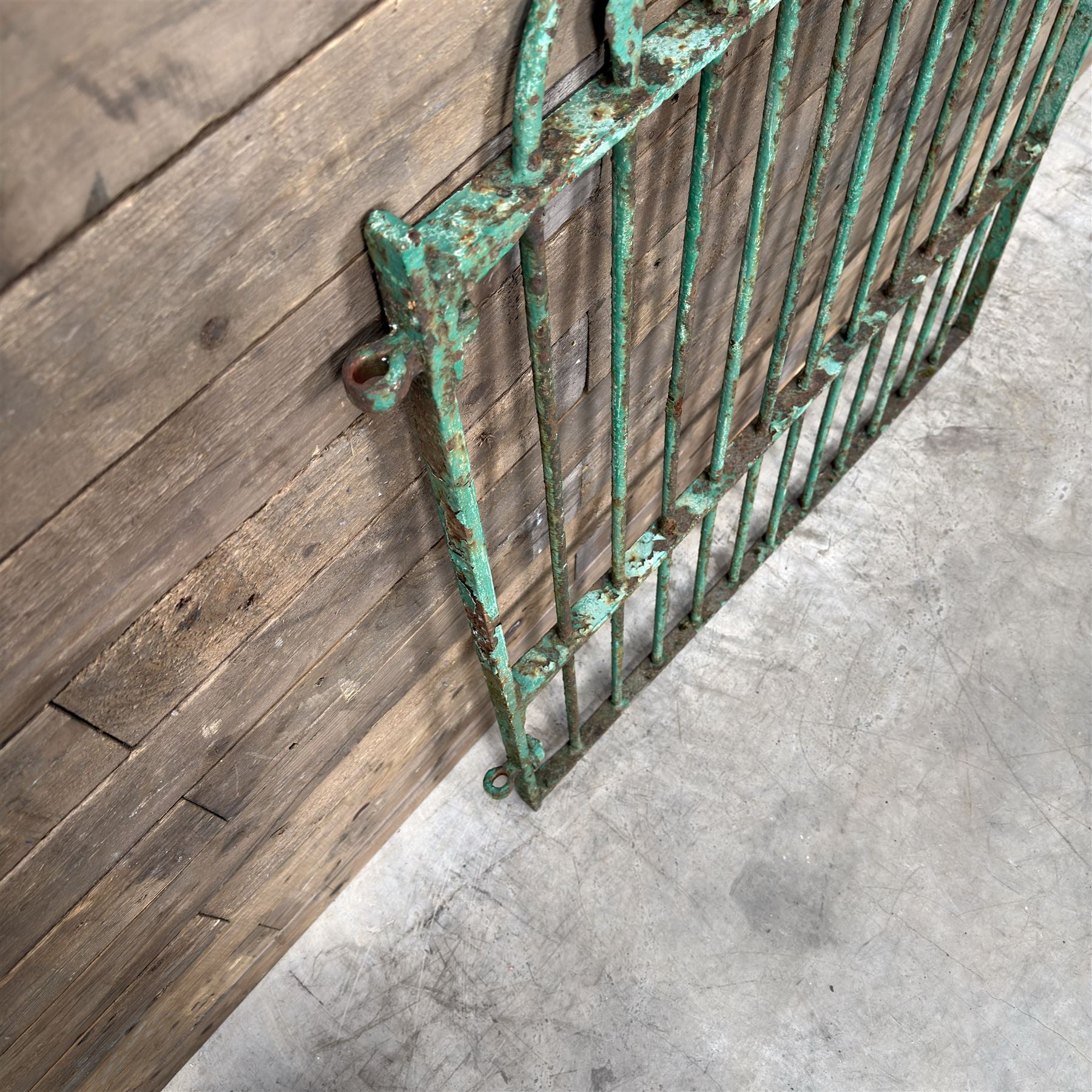 19th century French cast iron garden gate, finished in green rustic paint, bar form with hoop and spear top, with loop hinge brackets