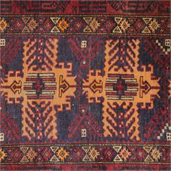 Baluch hand-knotted rug, deep red and indigo field decorated with a vertical arrangement of stylized geometric medallions within multiple narrow borders, 95x163cm, and Tekke Turkman rug, madder red field decorated with repeating rows of octagonal guls, framed by multiple geometric borders 84x129cm, (2)