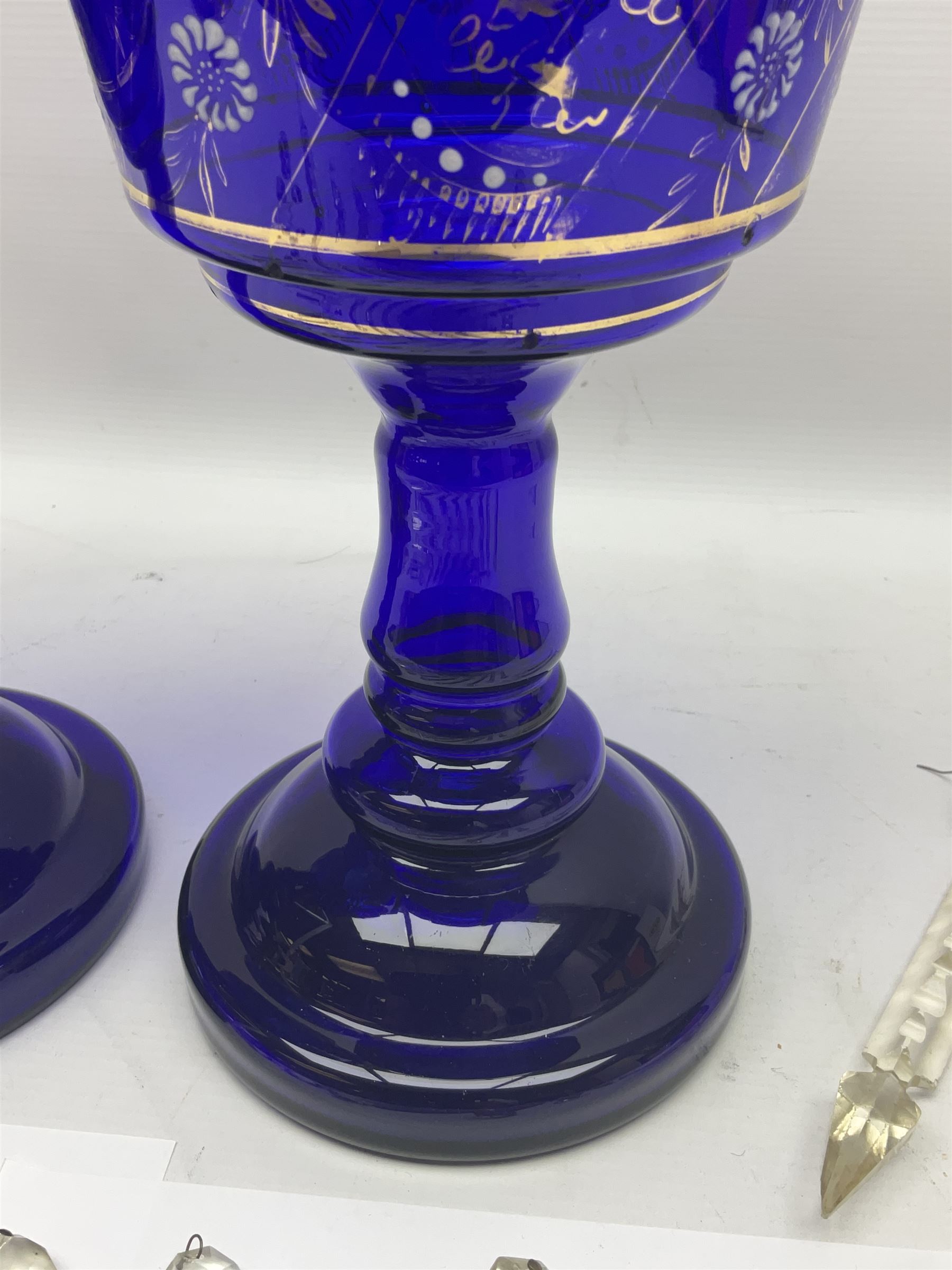 Pair of blue glass lustre vases, painted with white and gilt floral decoration, H32cm