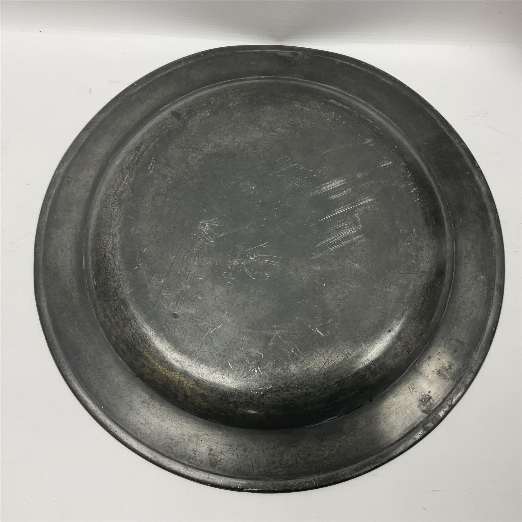 Group of seven 19th century pewter chargers, each of circular form with dished centre, two examples with touch marks verso, each approximately D39cm