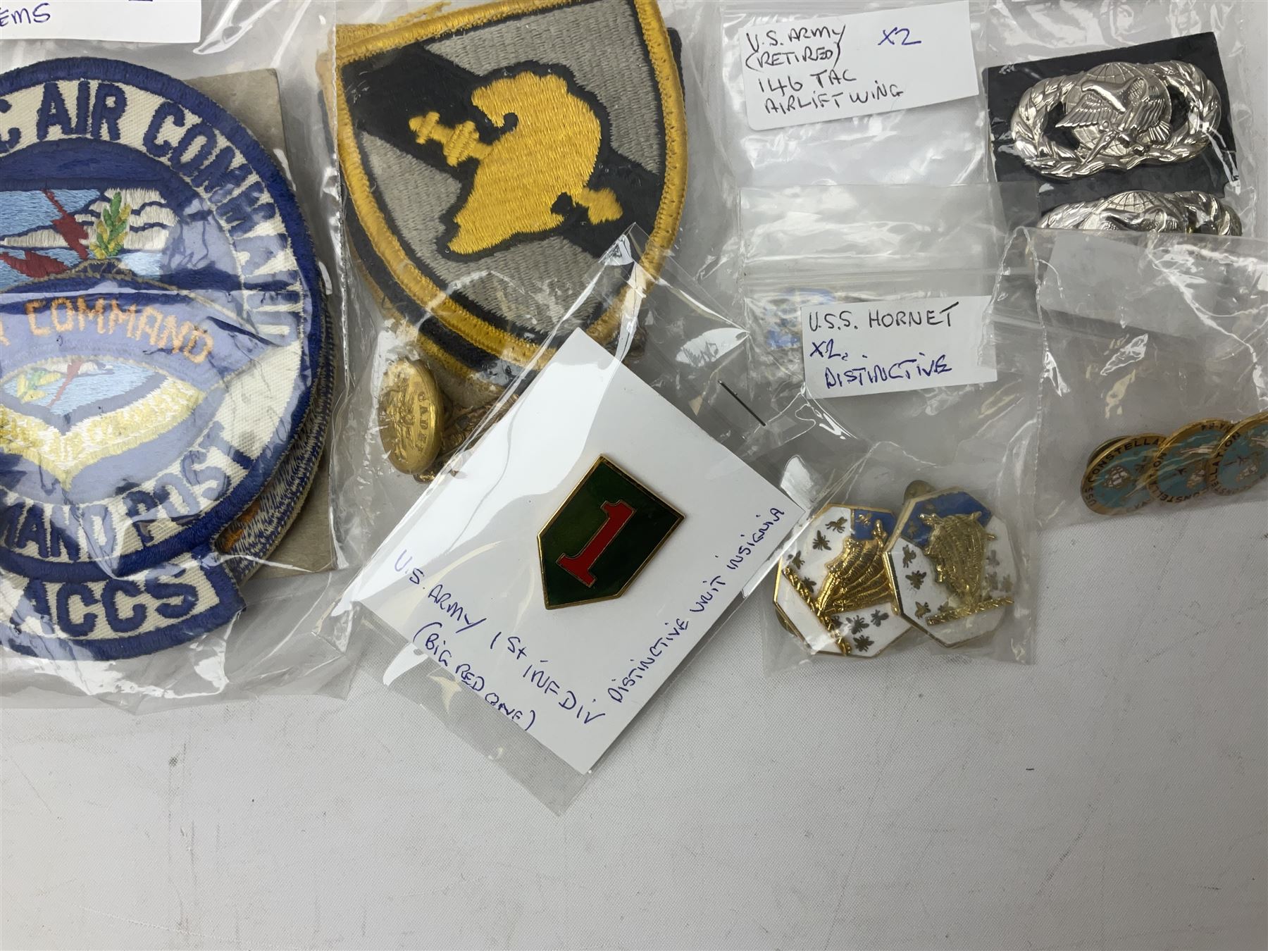 American patches and badges, including para wings, USS Constellation, Strategic Air Command, U.S. military academy, health service regt, Navy Seals, Air Defence Command, Seventh Fleet, various collar badges etc