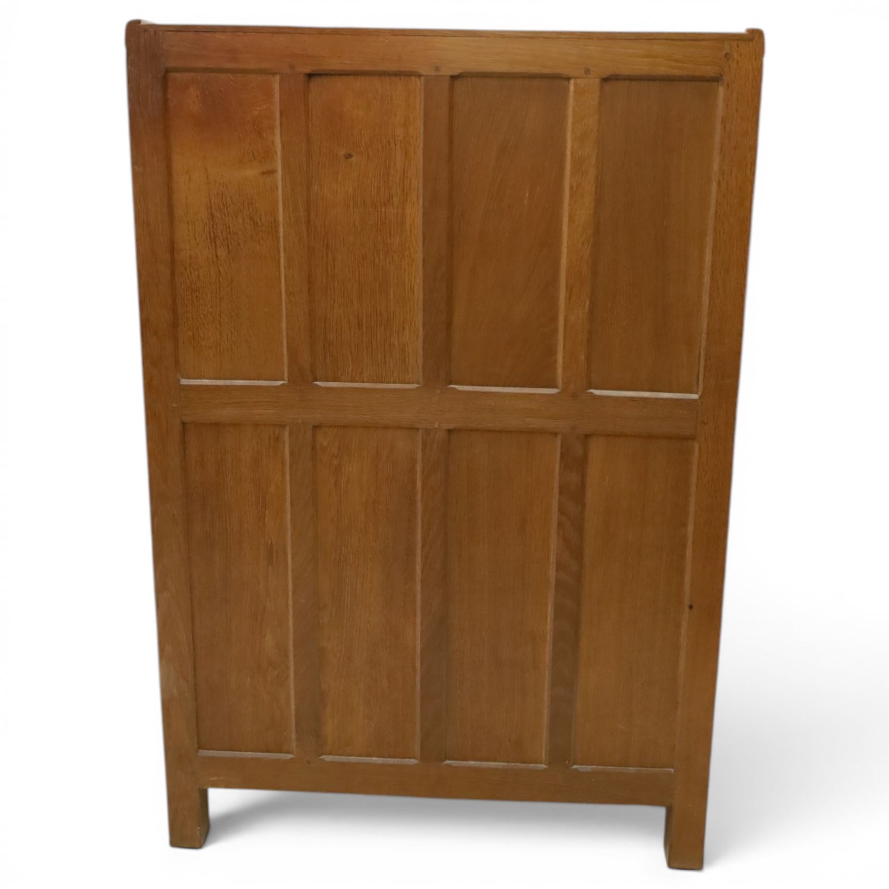 Mouseman - mid-20th century adzed and panelled oak tallboy chest, arcade carved cresting rail over two panelled cupboard doors with wrought iron fittings and latch, enclosing single shelf, over two short and two long drawers with lightly adzed facias and turned knob handles, raised on square supports, relief carved mouse signature, by the workshop of Robert Thompson of Kilburn