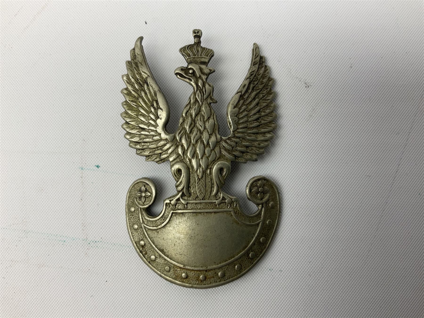 Three WW2 German visor cap badges comprising Police eagle, Political leaders eagle and Norwegian Quisling Party; all with fixings; and WW2 Polish visor cap badge (4)