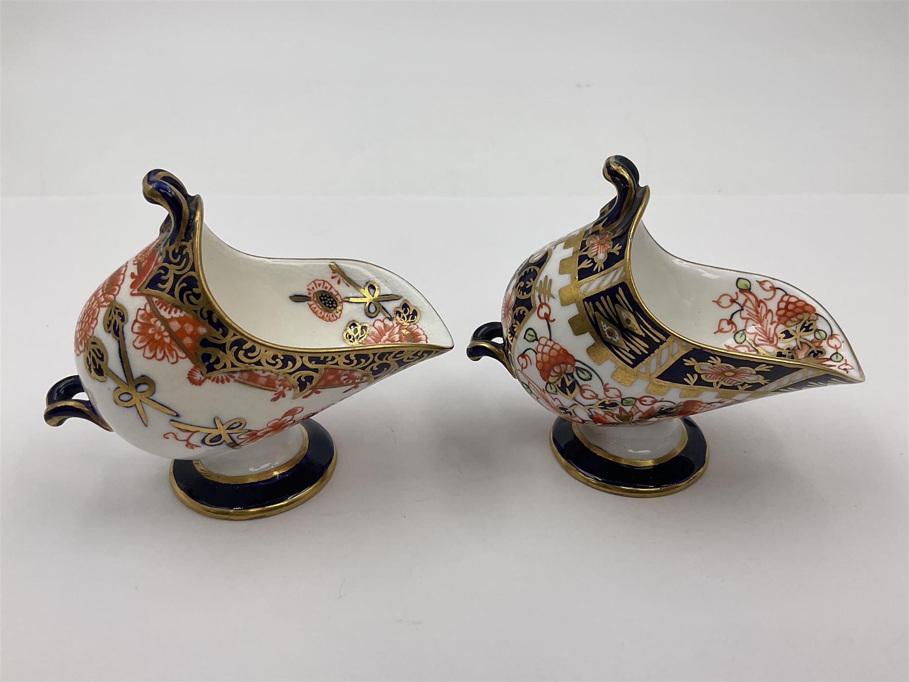 Group of Crown Derby and Royal Crown Derby Imari pattern miniatures, including mid 19th century Stevenson and Hancock cauldron, with painted mark beneath, H5.5cm, a near pair of early Royal Crown Derby scuttles, decorated in the 6299 pattern, each with printed and painted marks beneath including illustration date codes for 1913 and 1922, tallest 6.5cm, and a further early 20th century Royal Crown Derby scuttle, decorated in the 6299 pattern, with printed and painted marks beneath including illustration date code for 1922, H5.5cm, (4)
