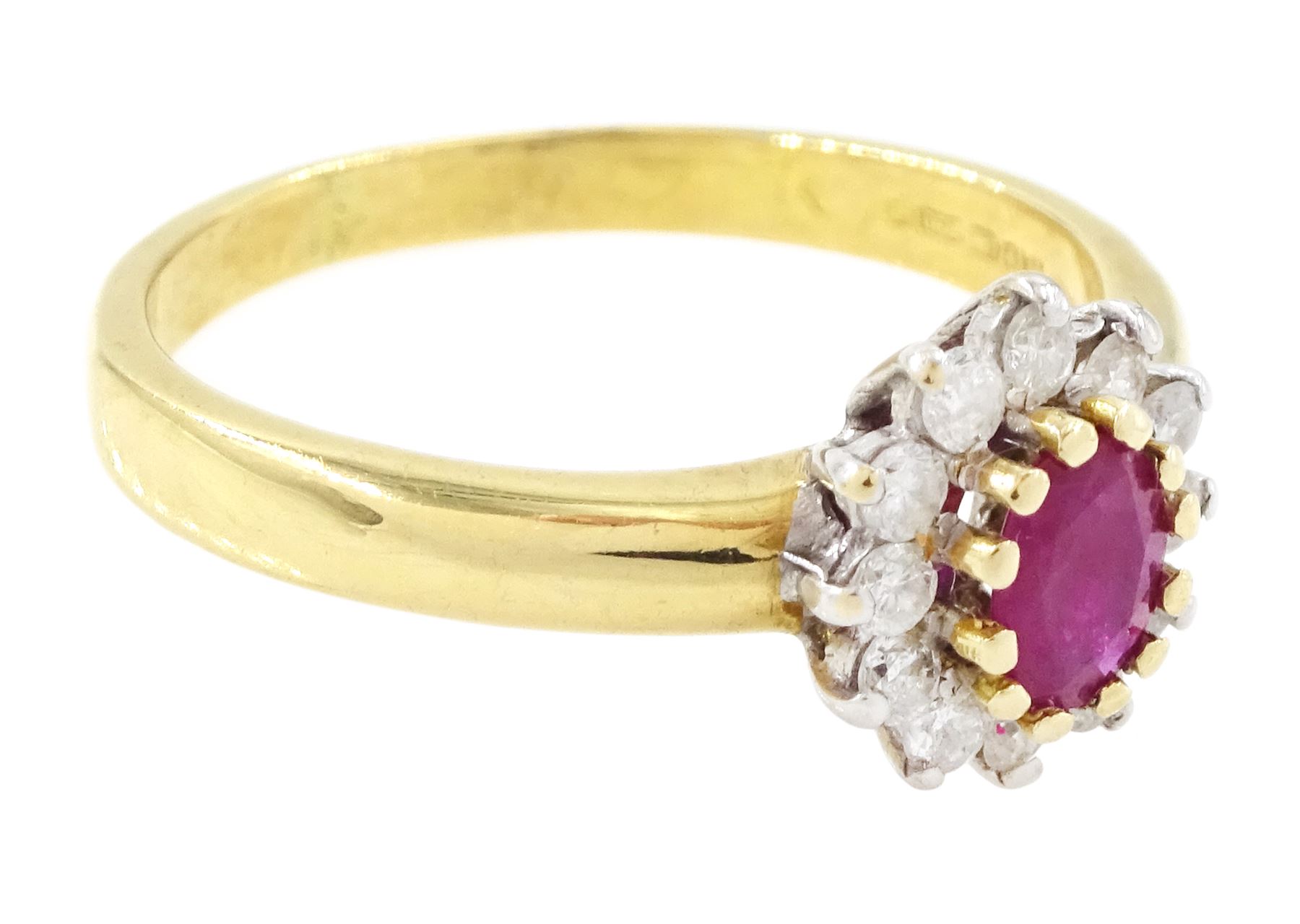 18ct gold ruby and diamond cluster ring, single oval cut ruby of approx 0.25 carat, surrounded by twelve round brilliant cut diamonds, hallmarked, total diamond weight 0.25 carat