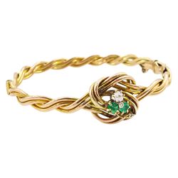 Early 20th century rose gold weave and knot hinged bangle, the central knot with old cut diamond and emerald three leaf clover decoration, stamped 9ct, diamond approx 0.15 carat