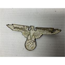 Two WW2 German 'SS' visor cap skull badges and another later; and visor cap eagle insignia (4)