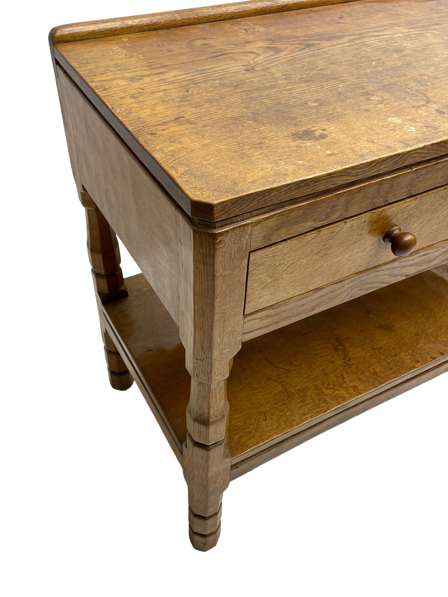Mouseman - circa. 1950s oak serving table, adzed rectangular top over two drawers, on octagonal supports joined by adzed undertier, the rear right leg carved with mouse signature, by Robert Thompson of Kilburn