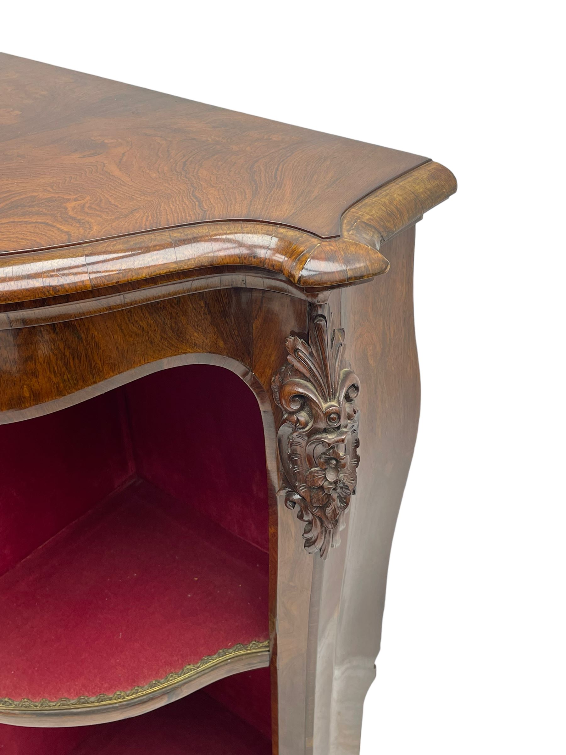 19th century rosewood buffet credenza, bombe form with shaped and moulded top, two central glazed doors with foliate moulded gilt slips, the red fabric-lined interior fitted with a single shelf, flanked by open shelves with raised gilt metal lips, the uprights decorated with shell and flower head carved cartouche mounts, acanthus leaf scroll carved lower mounts, on shaped and moulded plinth base 