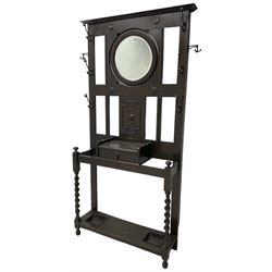 Edwardian oak hallstand, projecting moulded cornice over circular bevelled swing mirror, decorated with split beading and geometric mounts, fitted with single drawer and two stick or umbrella stands with drip trays, on spiral turned supports
