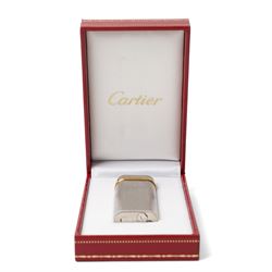 Cartier - silver-tone and gold-tone pocket lighter, with brushed vertical finish, hinged cover and gold-tone band signed Cartier, base signed Cartier and numbered, with original fitted presentation box, outer box and international guarantee booklet