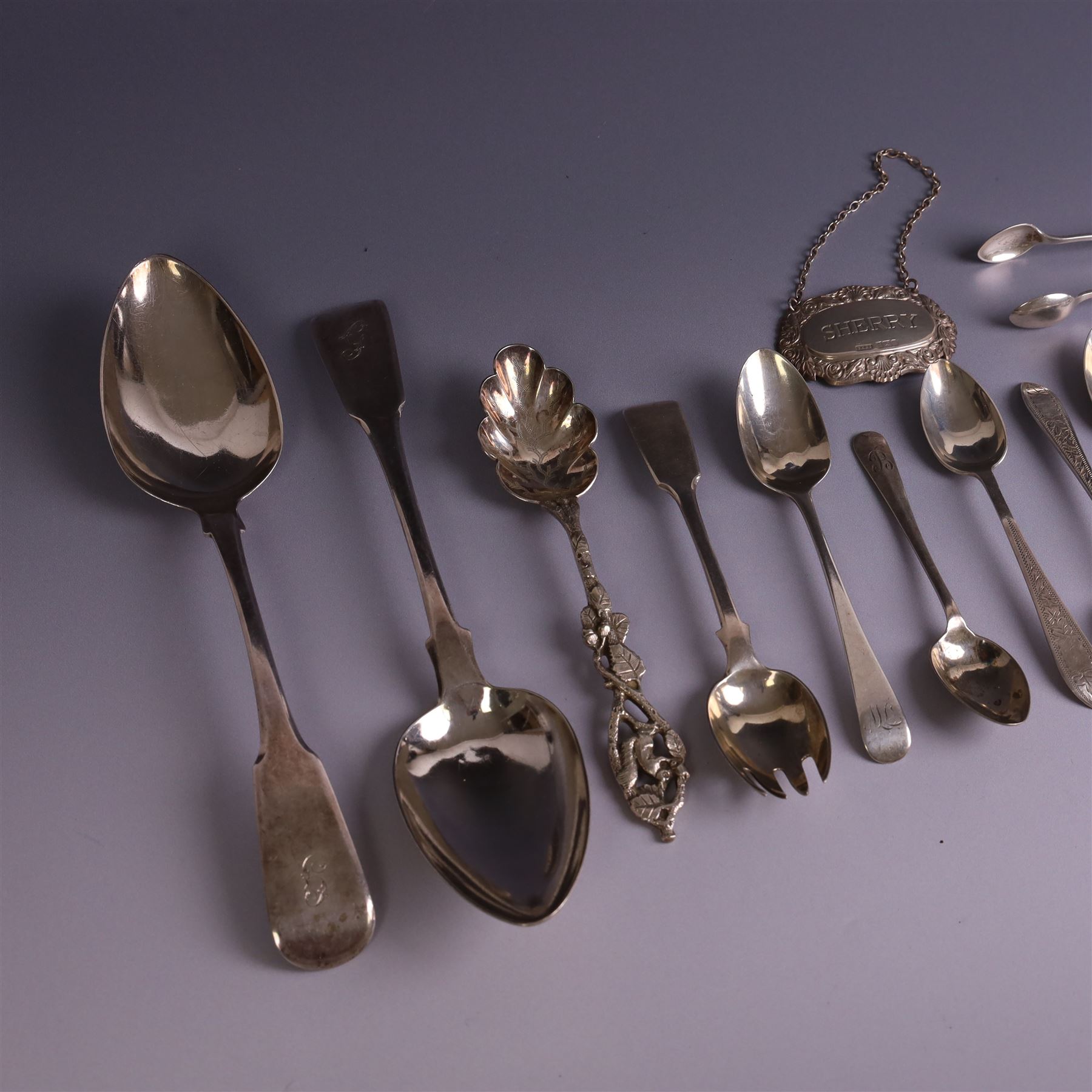 Collection of silver flatware, including pair of George III Fiddle patter table spoons and set of six Edwardian teaspoons with ivy decoration and matching sugar tongs, together with a silver 'Sherry' decanter label