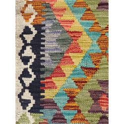 Tibetan-design handwoven rug, deep red field with three central medallions in yellow and blue, traditional yellow key border, white fringes on both ends