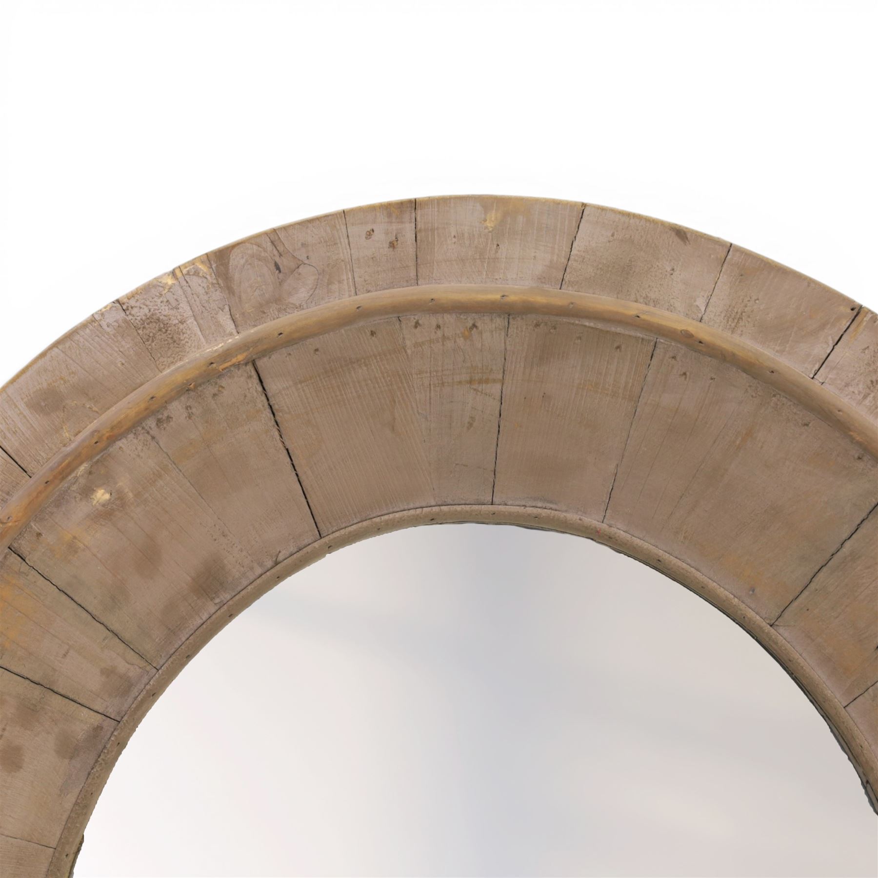 Rusticated driftwood wall mirror, of oval form, the mirror plate within a panelled driftwood frame, overall H83cm W70cm