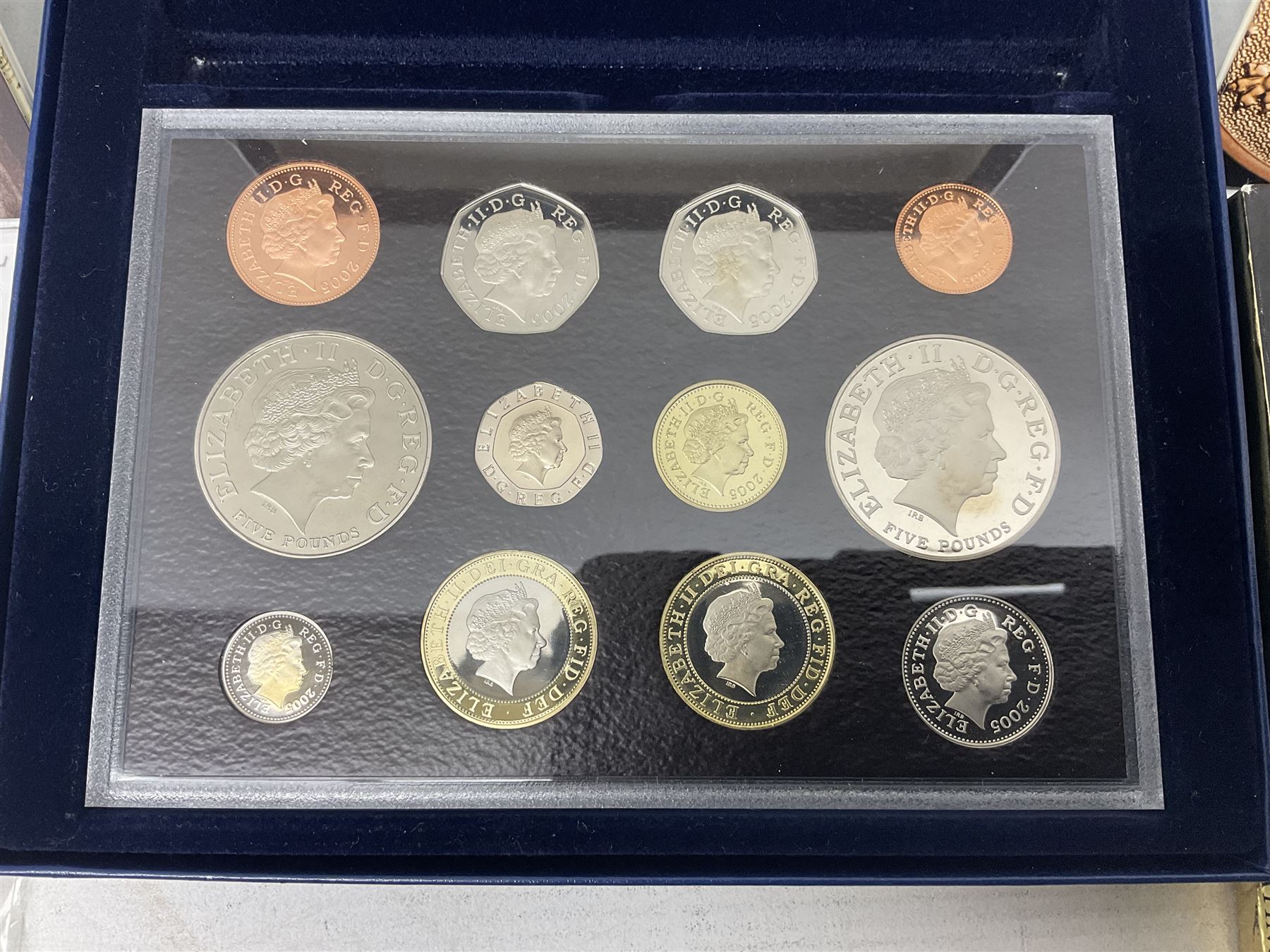 The Royal Mint United Kingdom 2005 proof coin set, with certificate, 2009 'Henry VIII' brilliant uncirculated fine pound coin, 2010 brilliant uncirculated coin collection, 2015 'The Fourth and Fifth Circulating Coinage Portrait Collection', and 'Farewell and Nations of the Crown UK' one pound brilliant uncirculated two coin set, all cased or in card folders