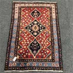 Persian style red and blue ground rug, repeating border, 131cm x 85cm  
