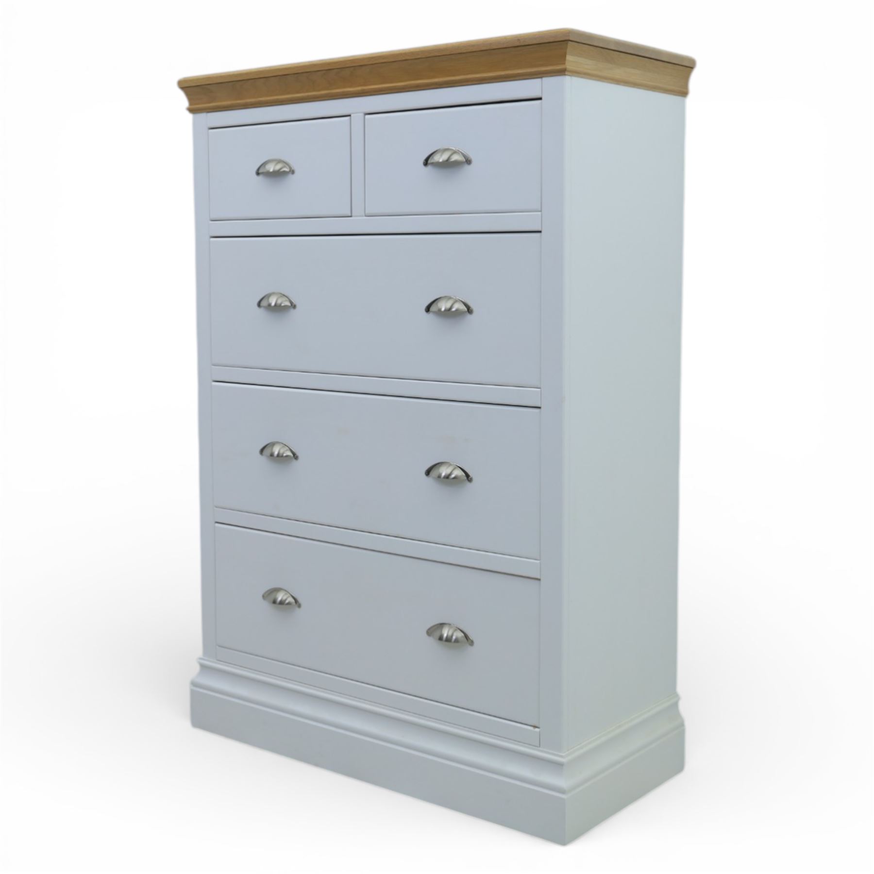 Modern chest of two short and three long drawers in white finish with oak moulded top, with metal cup handles, raised on a moulded plinth base