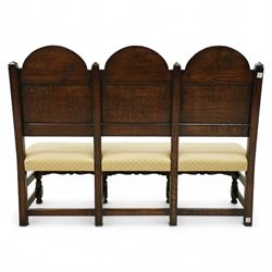 Bylaw of Ross On Wye - 17th-century design oak three-seat hall bench, triple arched panelled back, padded seat upholstered in a yellow herringbone ground fabric with star motif, raised on turned baluster legs united and turned front stretcher