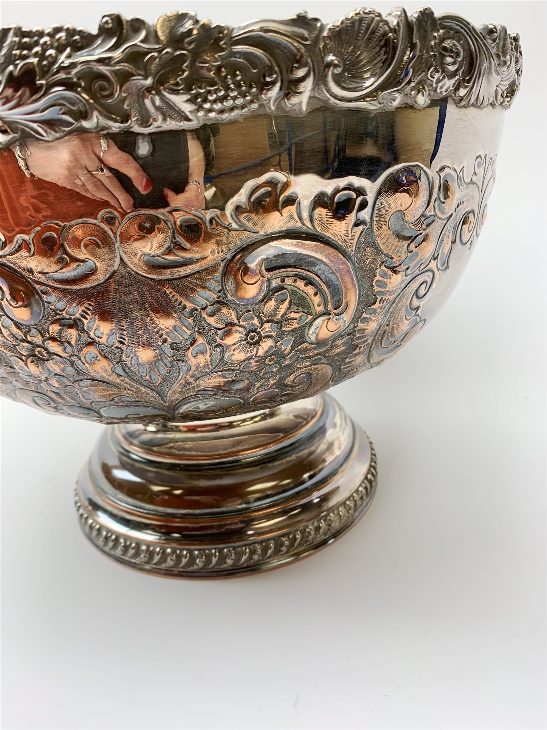 An early 20th century Barker Ellis Silver Co Ltd silver plated punch bowl, with embossed foliate detail to the body, applied rim with fruiting vines and acanthus leaves, and raised upon a stepped circular base with gadrooned detail, with MS shield mark beneath for Barker Ellis, H22c, D31cm. 