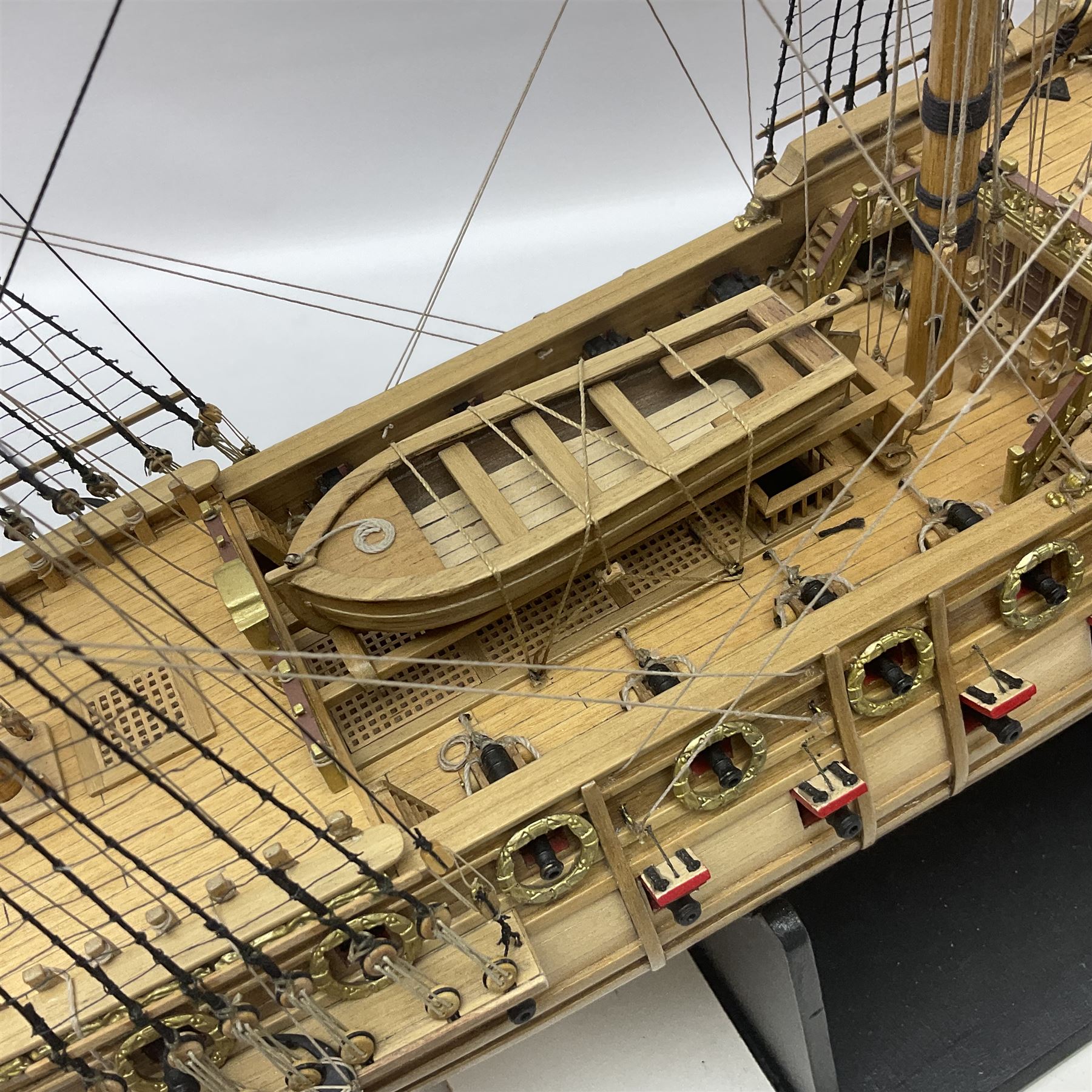 Wooden kit built model of HMS Neptune, 1:90 scale, with detailed rigging to three masts and a row of cannons to either side, upon ebonised wooden base, including stand H71cm