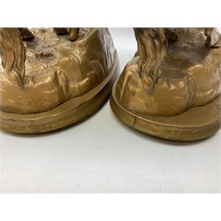 Pair of spelter mantel figural group sculptures of rearing horses and handlers on oval bases, H44cm