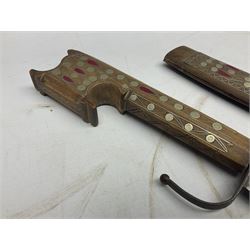 Late 19th/early 20th century Moroccan nimcha dagger-sword, the 40cm curving steel blade with engraved decoration on both sides; shaped hardwood hilt inlaid with brass, white metal wires and red coloured panels; in similarly inlaid scabbard L61cm overall
