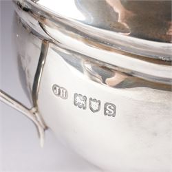 Silver three piece tea set of oval form, the teapot with ebonised handle and lift London 1913 Maker John Hunt and a pair of Victorian silver sugar tongs